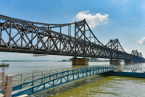 The steel bridge connecting the Yalu River in China to North Korea photo