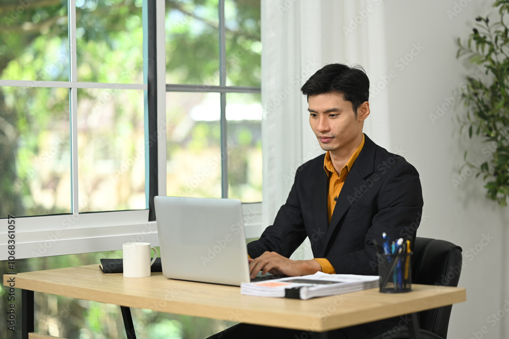 Professional businessman concentrating on work in a modern office Professional businessman concentrating on work in a modern office