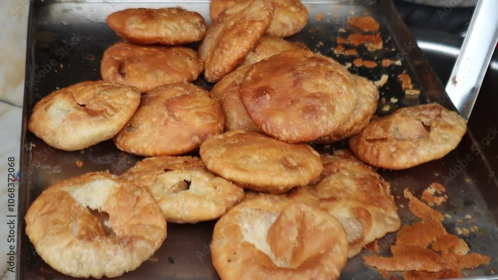 Crispy, golden Indian kachori served hot at a bustling street food shop, offering authentic flavors and a taste of traditional Indian cuisine. Selective focus Crispy, golden Indian kachori served hot at a bustling street food shop, offering authentic flavors and a taste of traditional Indian cuisine. Selective focus