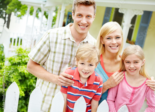 Love, portrait or kids on porch with happy family, smile and family by fence in home for fun bonding together. Parents, support or mom with dad, children or siblings on holiday vacation in Australia photo