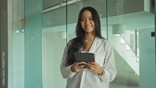 Tableau sur toile Attractive, young, asian, woman, standing, indoors, workplace, holding, tablet, smiling, confidently