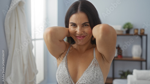Attractive brunette woman smiling indoors at a spa wellness center with shelves in the background Free Download Attractive brunette woman smiling indoors at a spa wellness center with shelves in the background - GFXLoad