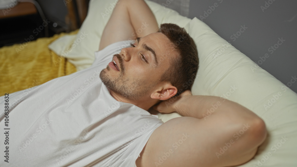 Handsome hispanic man with a beard relaxing in a white shirt on a comfortable bed in a cozy bedroom, creating a serene and peaceful indoor home atmosphere. Handsome hispanic man with a beard relaxing in a white shirt on a comfortable bed in a cozy bedroom, creating a serene and peaceful indoor home atmosphere.