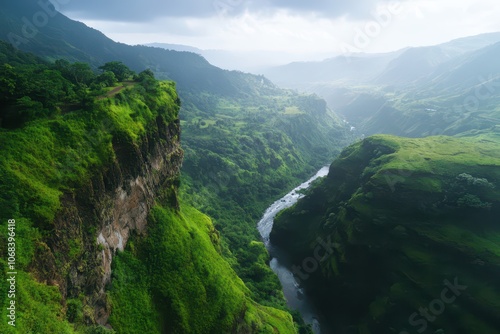 Majestic rocky cliffside adorned with lush greenery overlooking a serene river below.