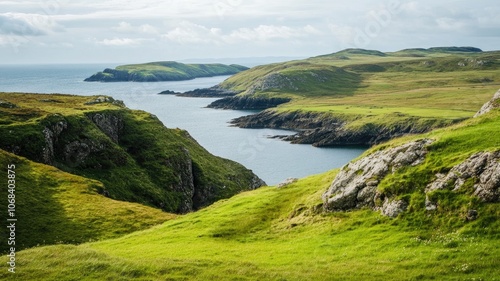 Coastal landscape with lush green hills and rocky cliffs under cloudy sky