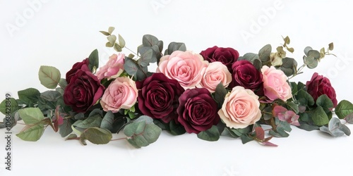 Fototapeta Naklejka Na Ścianę i Meble -  A collection of assorted pink and burgundy roses accompanied by eucalyptus is set against a white backdrop. This arrangement features a blend of lovely pink and rich burgundy hues.