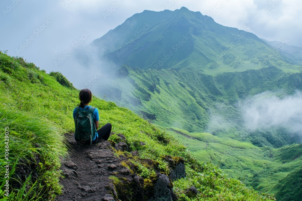 Embracing Nature's Serenity: A Solo Hiker Contemplates the Majestic Green Mountains and Mystical Clouds on a Scenic Trail Adventure Embracing Nature's Serenity: A Solo Hiker Contemplates the Majestic Green Mountains and Mystical Clouds on a Scenic Trail Adventure