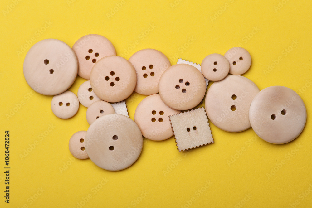 Wooden buttons on a yellow background close up Wooden buttons on a yellow background close up