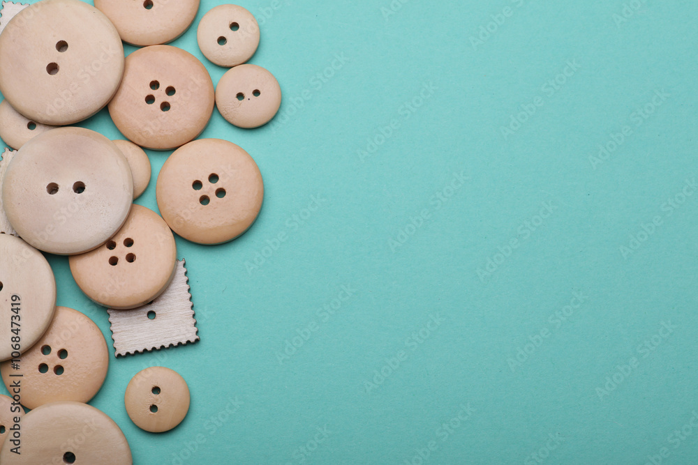 Wooden buttons on mint green background. Copy space Wooden buttons on mint green background. Copy space