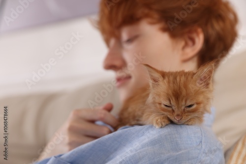 Wallpaper Mural Redhead teenage boy with cute ginger kitten indoors, selective focus Torontodigital.ca