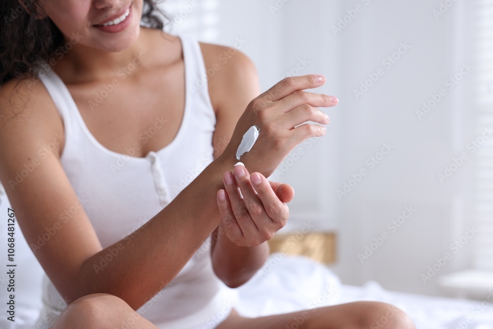 Woman applying cream onto hand at home, closeup. Space for text Woman applying cream onto hand at home, closeup. Space for text