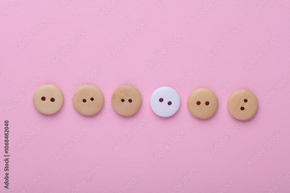 Wooden buttons on a pink background Wooden buttons on a pink background