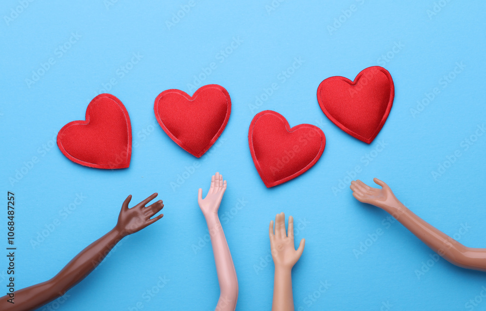 Hands of dolls and hearts on blue background Hands of dolls and hearts on blue background