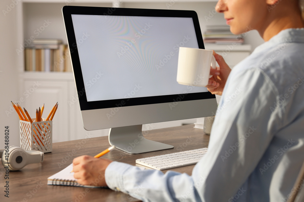 Woman working with computer monitor at wooden table in office, closeup. Mockup for design Woman working with computer monitor at wooden table in office, closeup. Mockup for design