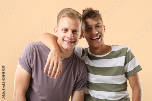 Portrait of happy brothers on beige background