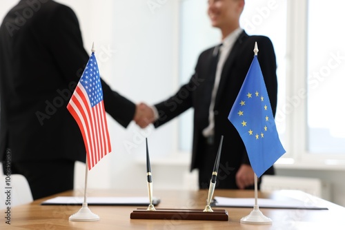 Canvas Print Diplomats shaking hands during meeting indoors, focus on flags of USA and Europe