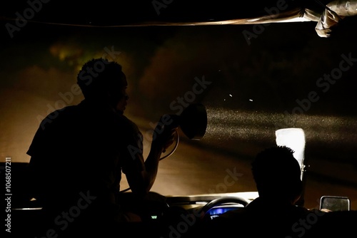Photography Safari guide looking for animals at night game drive