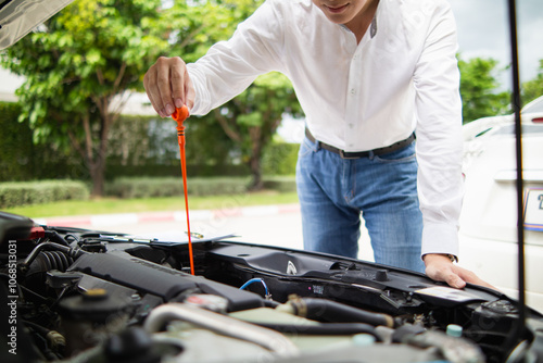 salesman is checking condition of car before delivering it to customer to ensure the quality and service after agreeing to sales contract. concept of checking the condition of the car for confidence photo