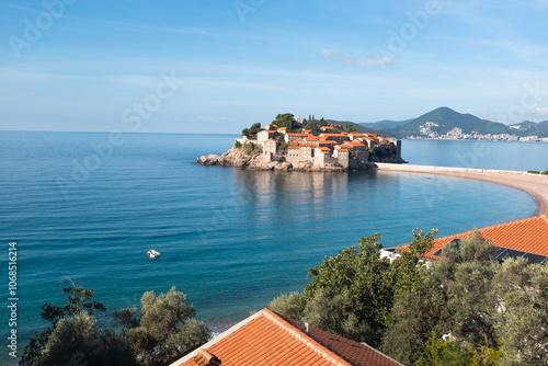 Scenic View of Saint Stefan Island in the Adriatic Sea, Montenegro. The picturesque island is surrounded by turquoise waters, sand beaches, and lush Mediterranean vegetation. High quality photography