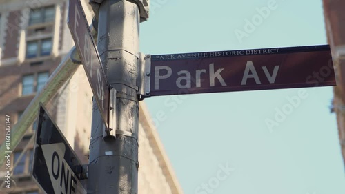 A detailed closeup view of the Park Avenue street sign beautifully set against a bustling city backdrop