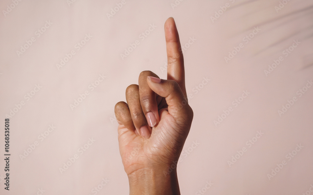 Index Finger Pointing Up Pose: An extreme close-up shot of a single hand with the index finger pointing upward, while the other fingers are folded Index Finger Pointing Up Pose: An extreme close-up shot of a single hand with the index finger pointing upward, while the other fingers are folded