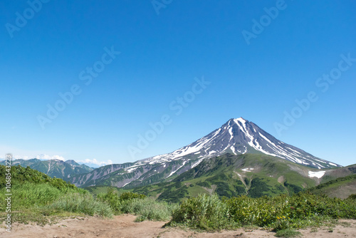 natural landscape in summer daytime view of high volcano Klyuchevskoy in Kamchatka photo