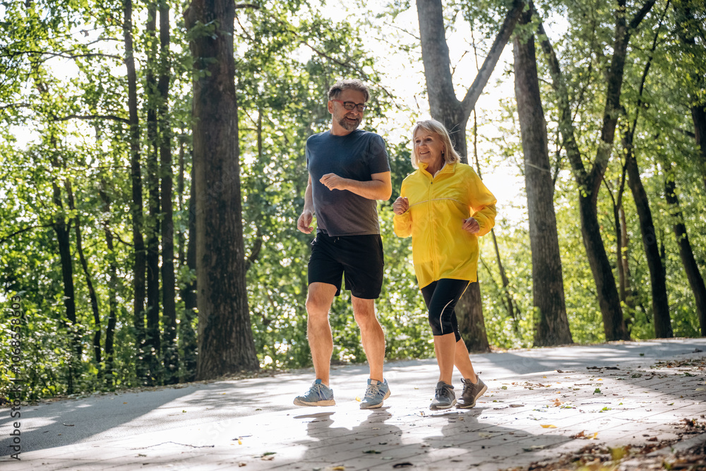 Jogging, conception of sport. Senior couple together outdoors at nature Jogging, conception of sport. Senior couple together outdoors at nature