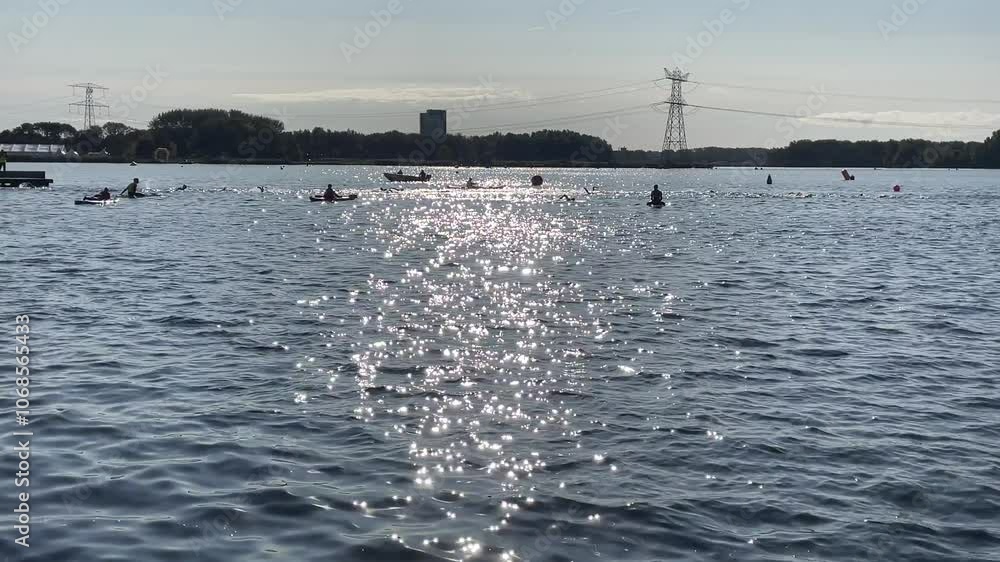 4k realtime, shimmering lake with people doing water sports in summer time, Almere, sup board, swimming 4k realtime, shimmering lake with people doing water sports in summer time, Almere, sup board, swimming