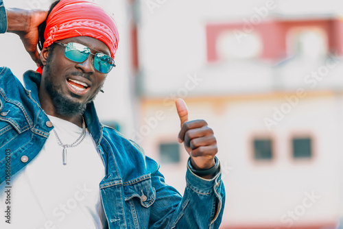 young african man wearing sunglasses and casual style on the street