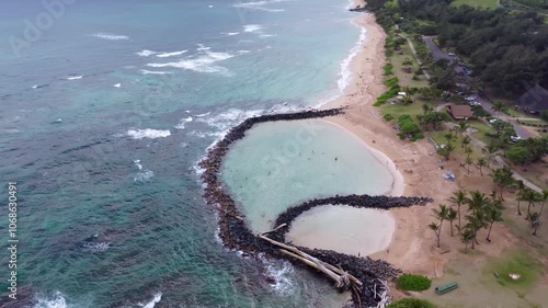 Aerial view of Lydgate Park Pools at Lydgate Beach park near Wailua bay in Kauai. Holiday in paradise. man made two large tide pools created by lava rock for safely swimming and snorkeling photo