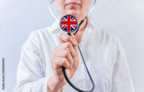 Doctor showing stethoscope with UK flag. UK National Healthcare concept...