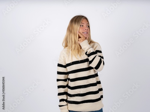 caucasian teen girl wearing striped knitted sweater over white Thinking worried about a question, concerned and nervous with hand on chin.