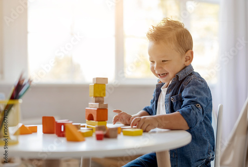 Adorable little toddler child sits at a white table, stacking vibrant blocks in various shapes and colors while beams of sunlight fill the room, creating a warm atmosphere.