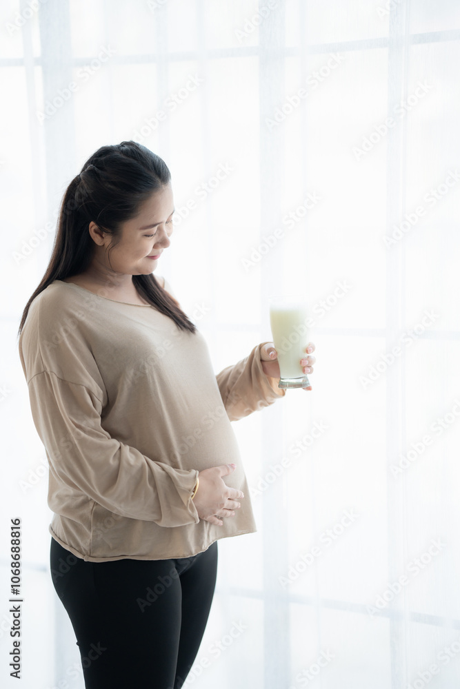 Pregnant asian woman drinking milk at home relaxation and Self-care Pregnancy drinking a glass of fresh milk mother mindfulness Positive life moment in pregnancy time Pregnant asian woman drinking milk at home relaxation and Self-care Pregnancy drinking a glass of fresh milk mother mindfulness Positive life moment in pregnancy time