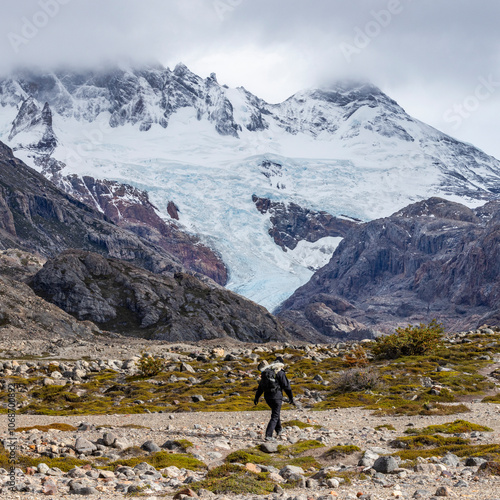 Argentina, Santa Cruz, El Chalten, Rear view of female hiker crossing rocky bed of Electrico River photo