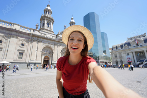 Holidays in Santiago de Chile. Beautiful smiling girl takes selfie photo in Plaza de Armas square, Santiago, Chile. photo