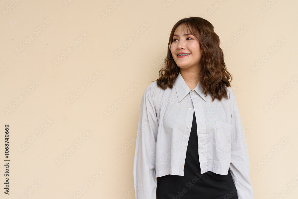 Portrait of Beautiful And Young Cute Asian Woman Against Plain Background Outdoors Portrait of Beautiful And Young Cute Asian Woman Against Plain Background Outdoors