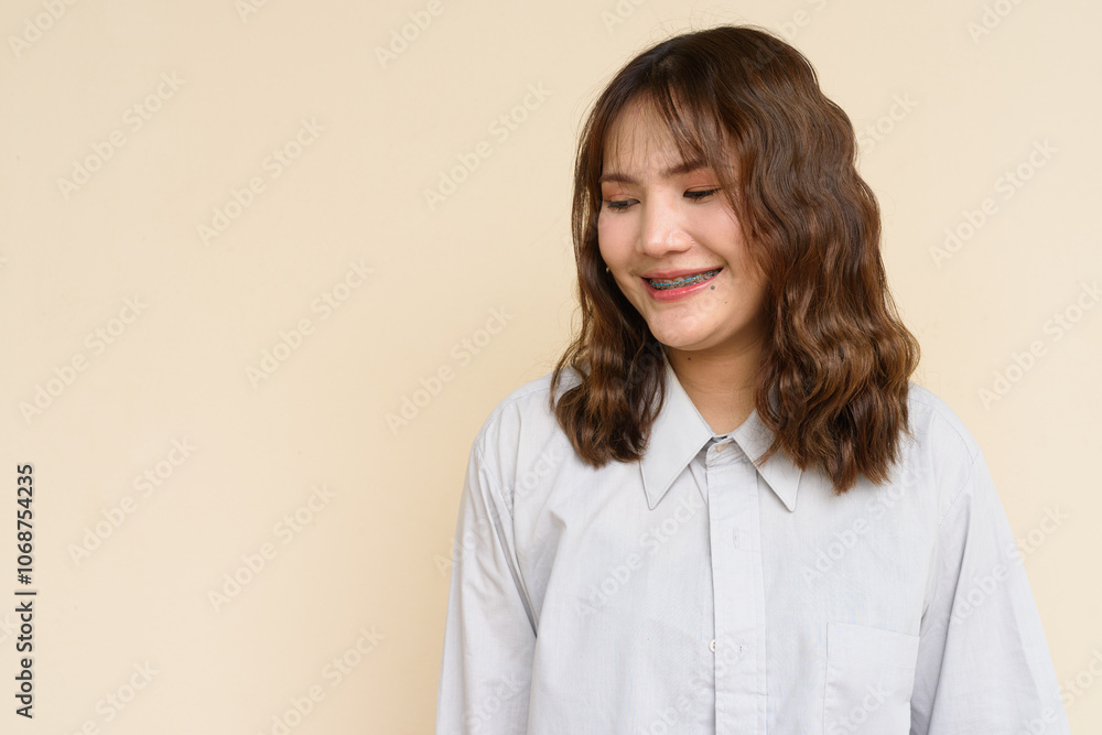 Portrait of Beautiful And Young Cute Asian Woman Against Plain Background Outdoors
