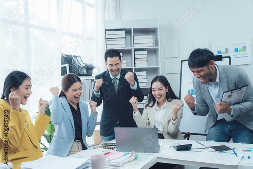 Canvas Print Business Team Celebrating Success: A diverse team of professionals in a modern office setting expresses their elation and excitement,  captured in a moment of shared triumph and unity