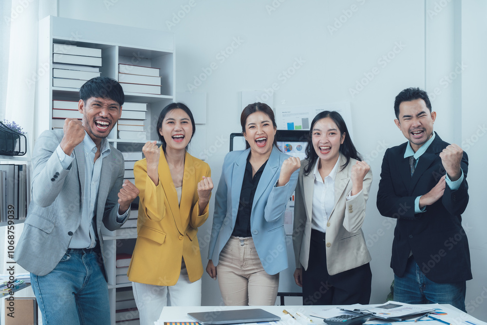 Team Success: A diverse team of business professionals celebrate their success with a collective fist pump, radiating joy and unity in their shared achievement. Team Success: A diverse team of business professionals celebrate their success with a collective fist pump, radiating joy and unity in their shared achievement.
