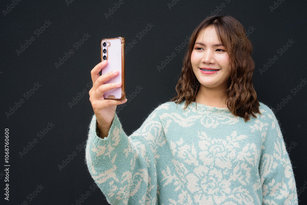 Portrait of Beautiful And Young Cute Asian Woman Against Dark Studio Background