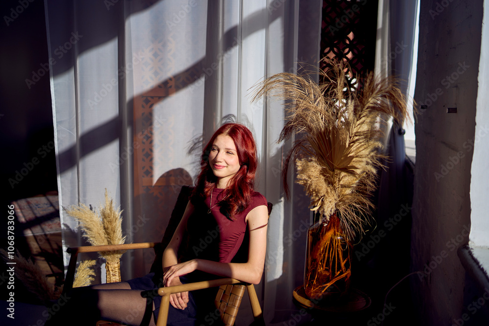 portrait of teenage girl with red hair in interior studio with hard light