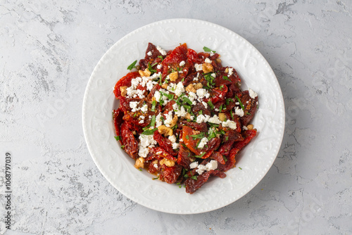 Traditional, delicious Turkish appetizers; Dried tomato appetizer salad with walnuts (Turkish name; Kurutulmus domates mezesi salatasi) photo