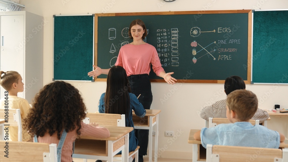 Instructor With Notebook Smart teacher checking cute student homework while explaining idea at ...