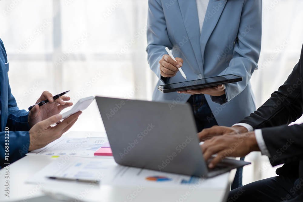 Business colleagues working and analyzing financial figures on a digital tablet. Analysis business financial report on digital tablet discussion meeting corporate showing results of their successful. Business colleagues working and analyzing financial figures on a digital tablet. Analysis business financial report on digital tablet discussion meeting corporate showing results of their successful.