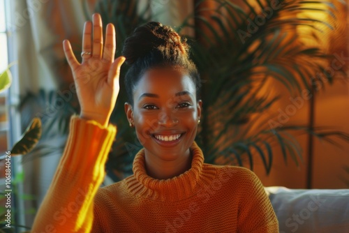 Smiling African American woman waving at webcam for video call photo