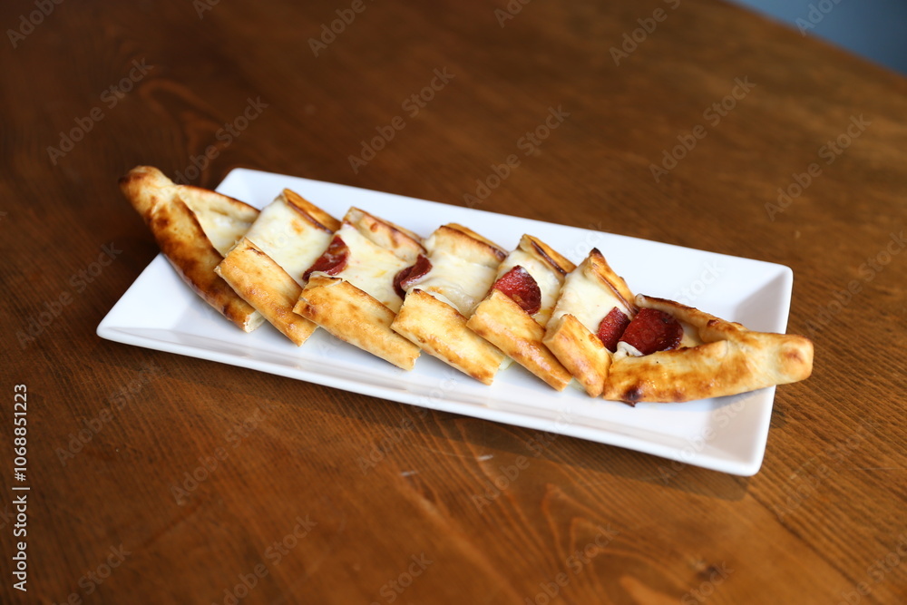 Crispy Turkish Pide with Cheese and Sujuk, Traditional Pastry, Mediterranean Cuisine, Savory Snack