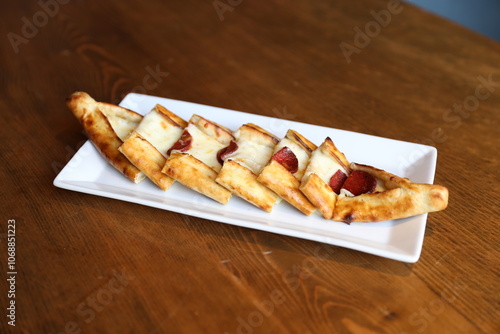 Crispy Turkish Pide with Cheese and Sujuk, Traditional Pastry, Mediterranean Cuisine, Savory Snack