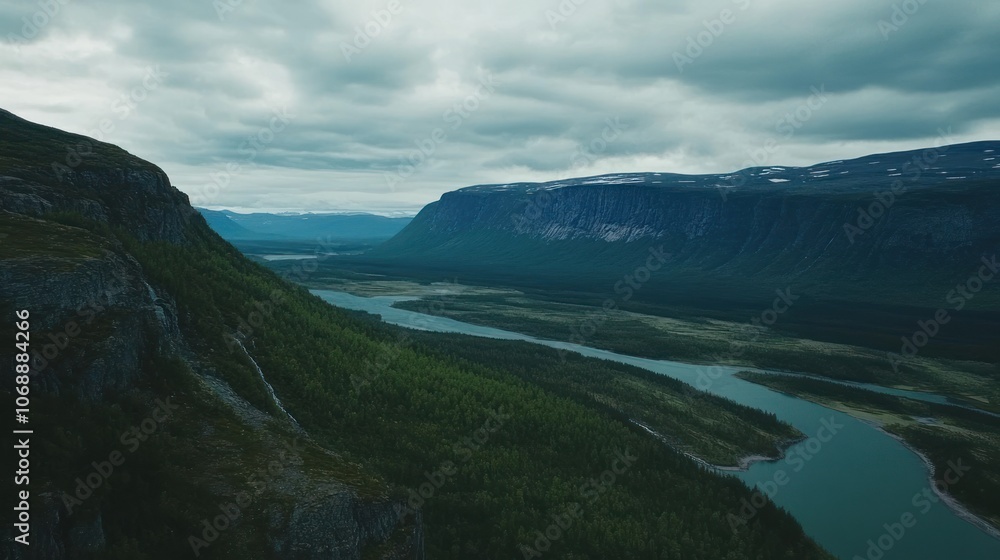 Aerial view of a vast river valley surrounded by green hills and rocky cliffs under a cloudy sky. Nature and landscape concept. Aerial view of a vast river valley surrounded by green hills and rocky cliffs under a cloudy sky. Nature and landscape concept.