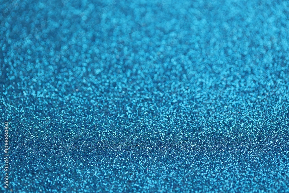 Beautiful blue glitter sparks texture as background with shallow depth of field Beautiful blue glitter sparks texture as background with shallow depth of field